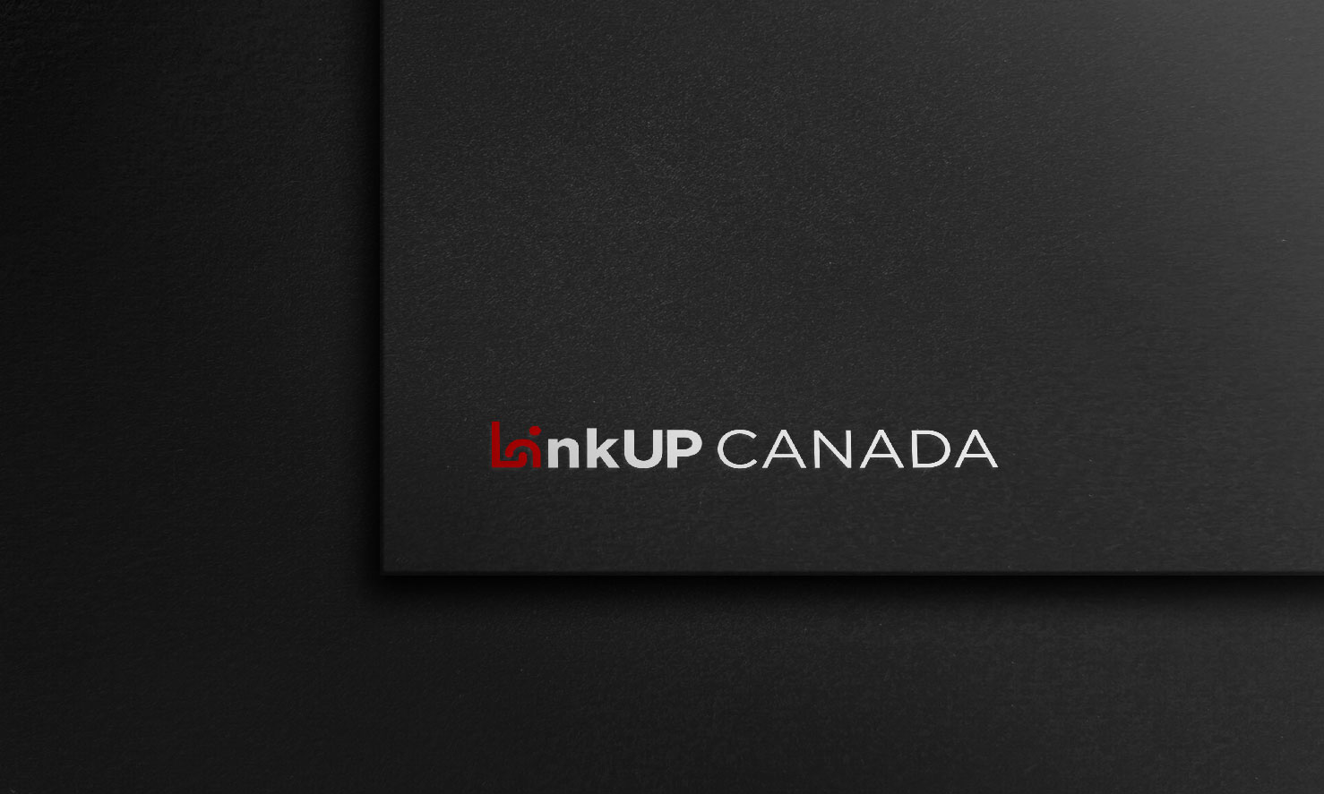 Black business card with the logo 'LinkUp CANADA' in white and red font on a textured dark background.