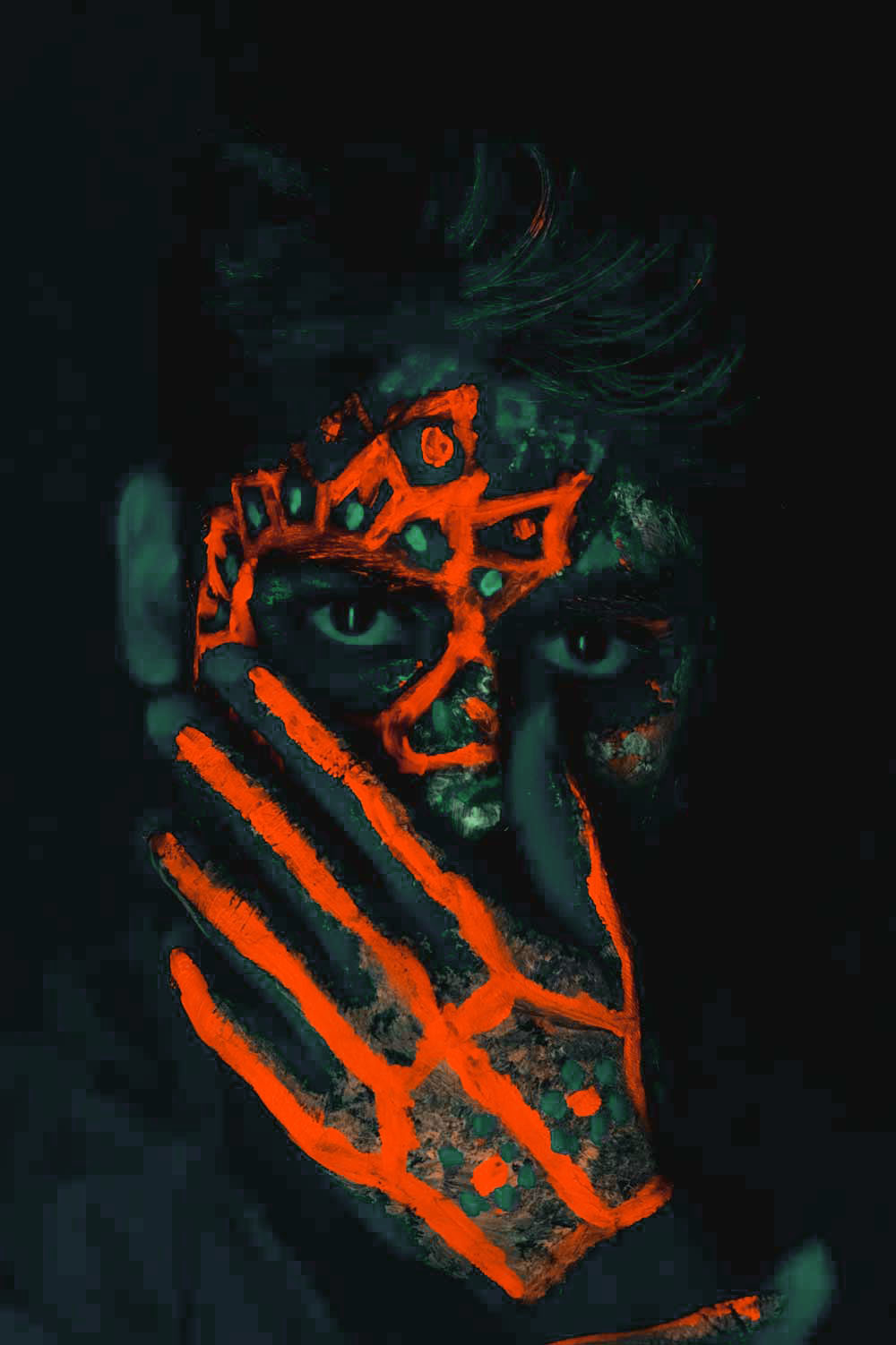 artistic image of a man with an orange painting on his face similar to mexican style of face painting with a dark and black background
