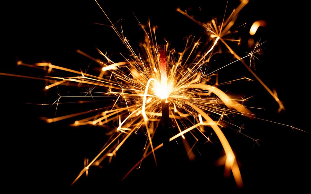 a spark of small firework light in a black background